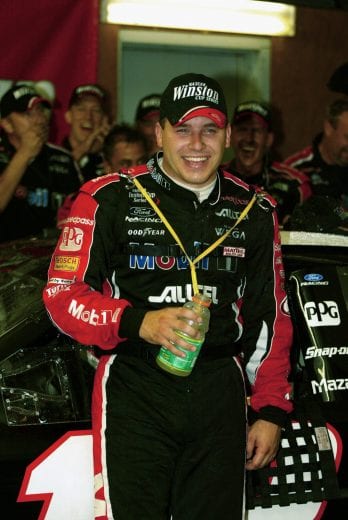 LOUDON, NH - SEPTEMBER 15: Ryan Newman, driver of the #12 Alltel/Mobile 1 Ford Taurus smiles after winning rain-shortened New Hampshire 300, part of the NASCAR Winston Cup Series, on September 15, 2002 at the New Hampshire International Speedway in Loudon, New Hampshire. (Photo by Donald Miralle/Getty Images) | Getty Images