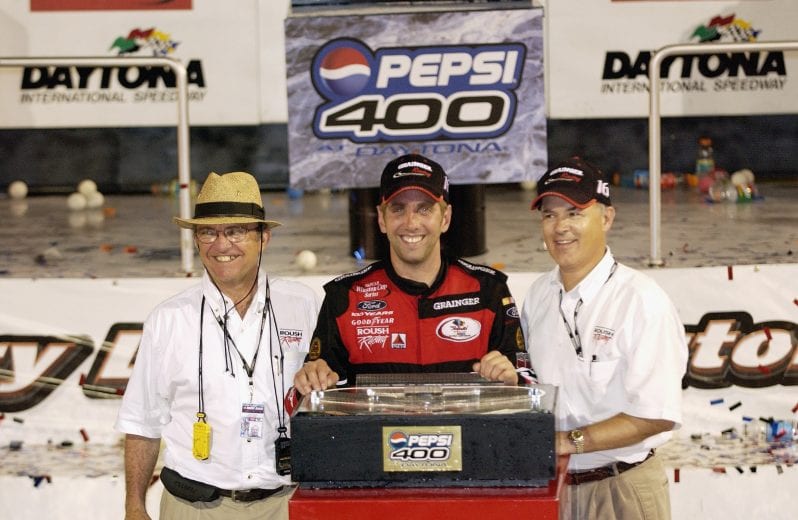 DAYTONA BEACH, FL - JULY 5: Greg Biffle, driver of the #16 Ford Taurus, poses for a photo after winning the Pepsi 400, on July 05, 2003 at Daytona International Speedway in Daytona Beach, Florida. (Photo By Rusty Jarrett/Getty Images) | Getty Images