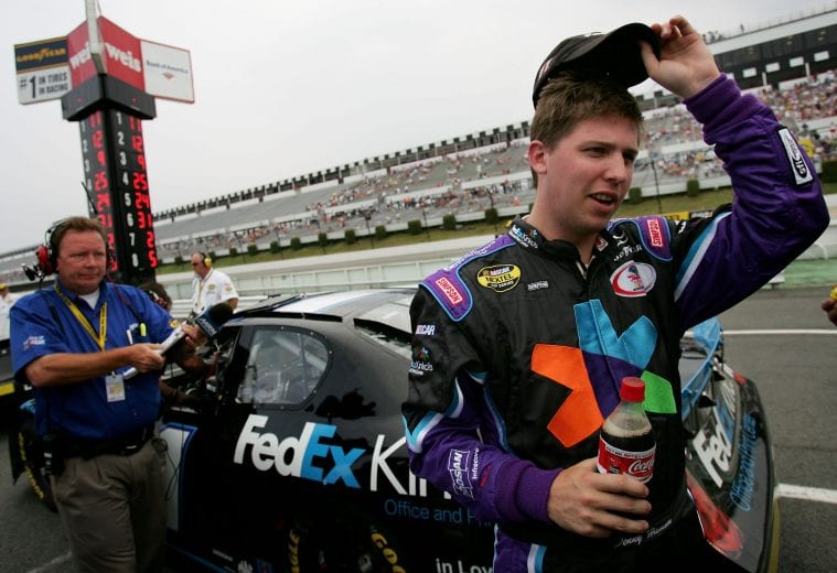 LONG POND, PA - JULY 21: Denny Hamlin, driver of the #11 FedEx Kinko's Chevrolet, stands on pit road during qualifying for the NASCAR Nextel Cup Series Pennsylvania 500 on July 21, 2006 at Pocono Raceway in Long Pond, Pennsylvania. (Photo by Doug Pensinger/Getty Images) | Getty Images