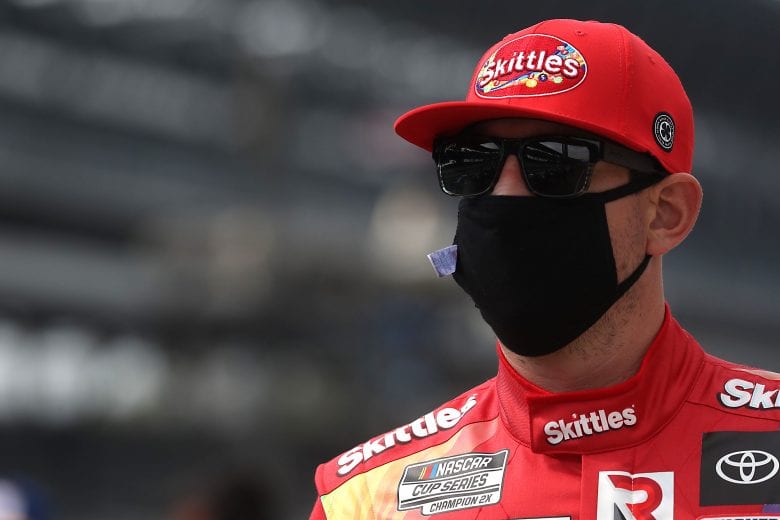 INDIANAPOLIS, INDIANA - JULY 05:  Kyle Busch, driver of the #18 Skittles Red White & Blue Toyota, walks the grid prior to the NASCAR Cup Series Big Machine Hand Sanitizer 400 Powered by Big Machine Records at Indianapolis Motor Speedway on July 05, 2020 in Indianapolis, Indiana. (Photo by Chris Graythen/Getty Images) | Getty Images