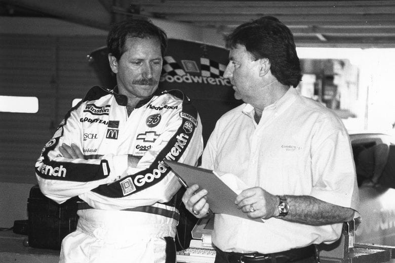 UNKNOWN — 1990s:  Driver Dale Earnhardt (L) and car owner Richard Childress (R) talk strategy in the garage area at a NASCAR Cup race in the 1990s.  (Photo by ISC Images & Archives via Getty Images)