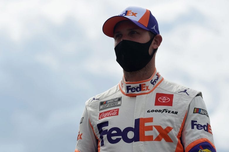 LONG POND, PENNSYLVANIA - JUNE 27: Denny Hamlin, driver of the #11 FedEx Ground Toyota, walks the grid prior to the NASCAR Cup Series Pocono Organics 325 in partnership with Rodale Institute at Pocono Raceway on June 27, 2020 in Long Pond, Pennsylvania. (Photo by Jared C. Tilton/Getty Images) | Getty Images