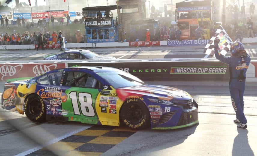 DOVER, DE - OCTOBER 01:  Kyle Busch, driver of the #18 M&M's Caramel Toyota, celebrates with the checkered flag after winning the Monster Energy NASCAR Cup Series Apache Warrior 400 presented by Lucas Oil at Dover International Speedway on October 1, 2017 in Dover, Delaware.  (Photo by Jerry Markland/Getty Images) | Getty Images