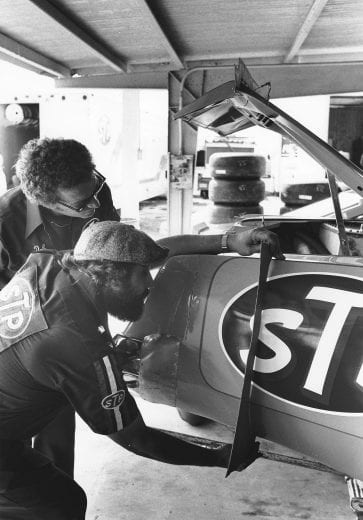 DAYTONA BEACH, FL - JULY 1979: Maurice Petty uses a template on the rear fender of Richard PettyÕs Oldsmobile as crew chief Dale Inman looks on in the garage area at Daytona International Speedway prior to the running of the Firecracker 400 NASCAR Cup race. (Photo by ISC Images & Archives via Getty Images)