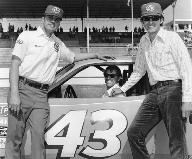 UNKNOWN — Early-1970s: Petty Enterprises crew chief Dale Inman sits in the racecar as brothers Maurice (L) and Richard Petty (R) pose at a NASCAR Cup race. (Photo by ISC Images & Archives via Getty Images)