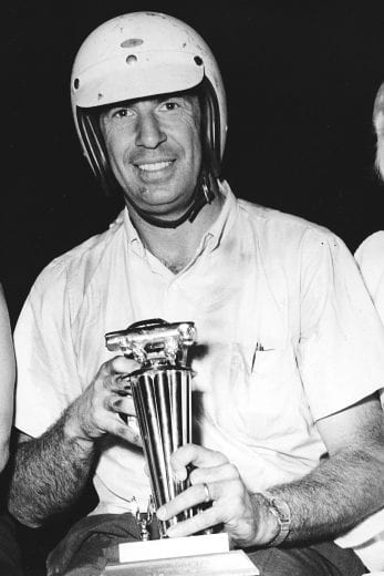 MOYOCK, NC — August 13, 1964: Ned Jarrett shows off his trophy in victory lane after he won the Moyock 300 NASCAR Cup race at Dog Track Speedway, just one of 15 wins Jarrett recorded during the Cup season. (Photo by ISC Images & Archives via Getty Images)