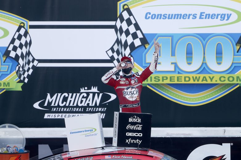 BROOKLYN, MICHIGAN - AUGUST 09: Kevin Harvick, driver of the #4 Busch Light Apple Ford, celebrates in Victory Lane after winning the NASCAR Cup Series Consumers Energy 400 at Michigan International Speedway on August 09, 2020 in Brooklyn, Michigan. (Photo by Brian Lawdermilk/Getty Images) | Getty Images