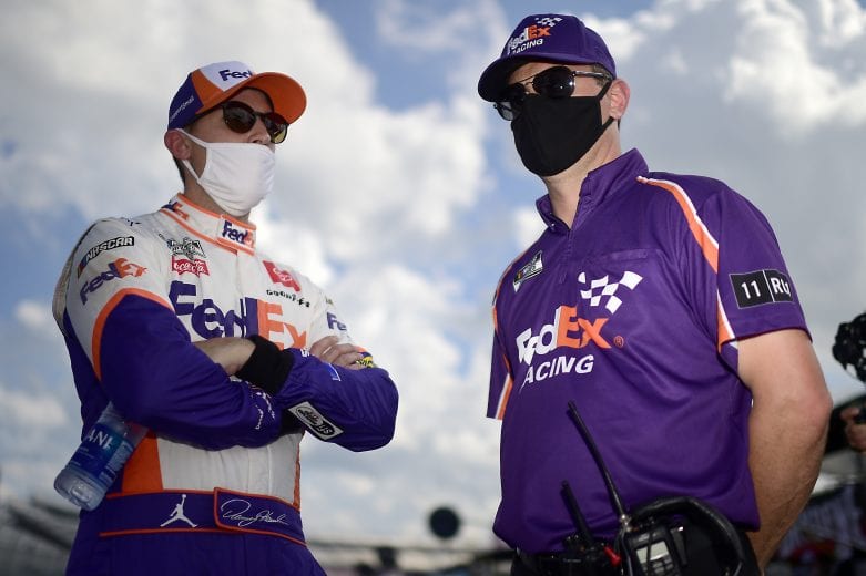 DOVER, DELAWARE - AUGUST 23: Denny Hamlin, driver of the #11 FedEx Office Toyota, and crew chief Christopher Gabehart talk on the grid prior to the NASCAR Cup Series Drydene 311 at Dover International Speedway on August 23, 2020 in Dover, Delaware. (Photo by Jared C. Tilton/Getty Images) | Getty Images
