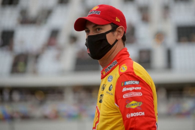 DAYTONA BEACH, FLORIDA - AUGUST 29: Joey Logano, driver of the #22 Shell Pennzoil Ford, walks on the grid prior to the NASCAR Cup Series Coke Zero Sugar 400 at Daytona International Speedway on August 29, 2020 in Daytona Beach, Florida. (Photo by Chris Graythen/Getty Images) | Getty Images