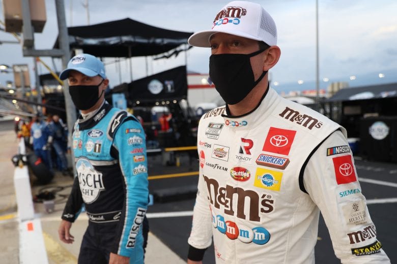 CONCORD, NORTH CAROLINA - MAY 24: Kyle Busch, driver of the #18 M&M's Red White Blue Toyota, and Kevin Harvick, driver of the #4 Busch Light Ford, walk back onto pit road after a rain delay during the NASCAR Cup Series Coca-Cola 600 at Charlotte Motor Speedway on May 24, 2020 in Concord, North Carolina. (Photo by Chris Graythen/Getty Images) | Getty Images