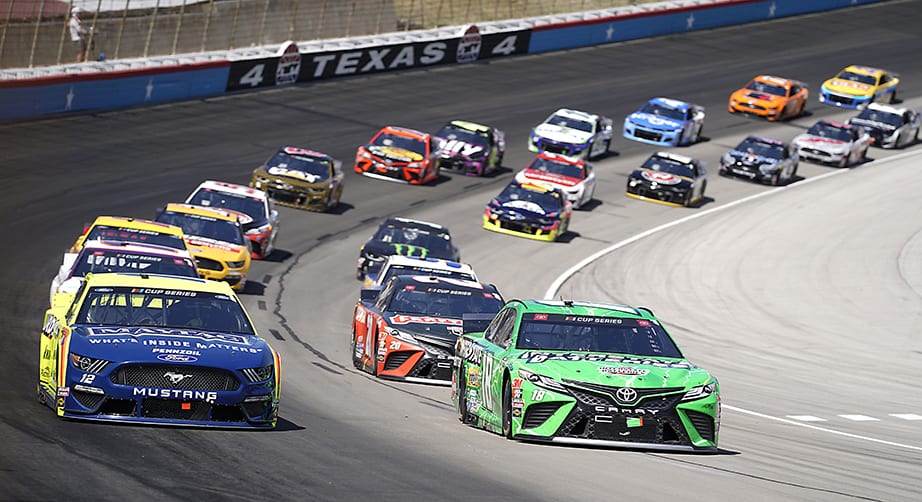 FORT WORTH, TEXAS - JULY 19: Ryan Blaney, driver of the #12 Menards/Maytag Ford, and Kyle Busch, driver of the #18 Interstate Batteries Toyota, lead the field during the NASCAR Cup Series O'Reilly Auto Parts 500 at Texas Motor Speedway on July 19, 2020 in Fort Worth, Texas. (Photo by Cooper Neill/Getty Images)