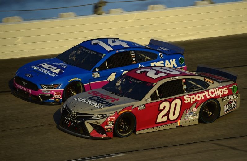 DARLINGTON, SOUTH CAROLINA - SEPTEMBER 06: Erik Jones, driver of the #20 Sport Clips Toyota, and Clint Bowyer, driver of the #14 PEAK Throwback Ford, race during the NASCAR Cup Series Cook Out Southern 500 at Darlington Raceway on September 06, 2020 in Darlington, South Carolina. (Photo by Jared C. Tilton/Getty Images) | Getty Images