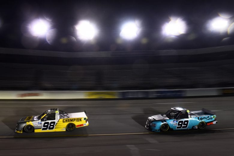 RICHMOND, VIRGINIA - SEPTEMBER 10: Grant Enfinger, driver of the #98 Champion/Curb Records Ford, and Ben Rhodes, driver of the #99 Tenda Heal Ford,  race during the NASCAR Gander Outdoors Truck Series ToyotaCare 250 at Richmond Raceway on September 10, 2020 in Richmond, Virginia. (Photo by Jared C. Tilton/Getty Images) | Getty Images