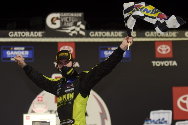 RICHMOND, VIRGINIA - SEPTEMBER 10: Grant Enfinger, driver of the #98 Champion/Curb Records Ford, celebrates in Victory Lane after winning  the NASCAR Gander Outdoors Truck Series ToyotaCare 250 at Richmond Raceway on September 10, 2020 in Richmond, Virginia. (Photo by Jared C. Tilton/Getty Images) | Getty Images