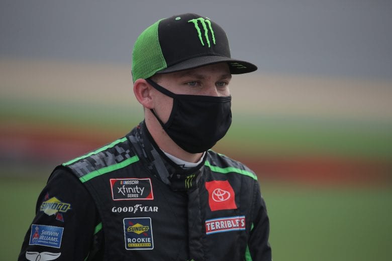DAYTONA BEACH, FLORIDA - AUGUST 28: Riley Herbst, driver of the #18 Monster Energy Toyota, walks the grid prior to  the NASCAR Xfinity Series Wawa 250 Powered by Coca-Cola at Daytona International Speedway on August 28, 2020 in Daytona Beach, Florida. (Photo by Chris Graythen/Getty Images) | Getty Images