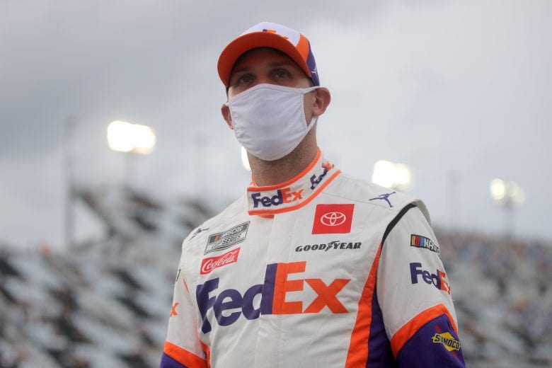 DAYTONA BEACH, FLORIDA - AUGUST 29: Denny Hamlin, driver of the #11 FedEx Express Toyota, walks on the grid prior to the NASCAR Cup Series Coke Zero Sugar 400 at Daytona International Speedway on August 29, 2020 in Daytona Beach, Florida. (Photo by Chris Graythen/Getty Images) | Getty Images