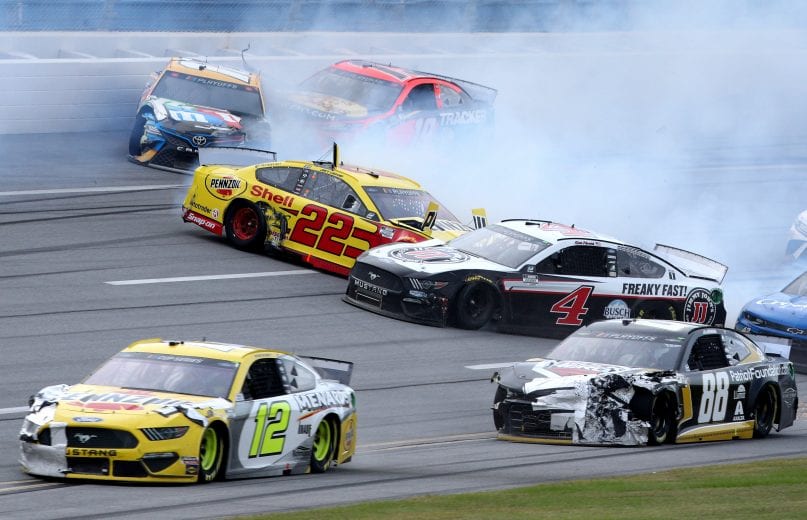 TALLADEGA, ALABAMA - OCTOBER 04: Joey Logano, driver of the #22 Shell Pennzoil Ford, Kevin Harvick, driver of the #4 Jimmy John's Ford, Kyle Busch, driver of the #18 M&M's Toyota, and Martin Truex Jr., driver of the #19 Bass Pro Shops Toyota, are involved in an on-track incident during the NASCAR Cup Series YellaWood 500 at Talladega Superspeedway on October 04, 2020 in Talladega, Alabama. (Photo by Chris Graythen/Getty Images) | Getty Images
