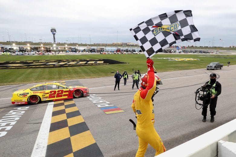 KANSAS CITY, KANSAS - OCTOBER 18: Joey Logano, driver of the #22 Shell Pennzoil Ford, celebrates with the checkered flag after winning the NASCAR Cup Series  Hollywood Casino 400 at Kansas Speedway on October 18, 2020 in Kansas City, Kansas. (Photo by Jamie Squire/Getty Images) | Getty Images