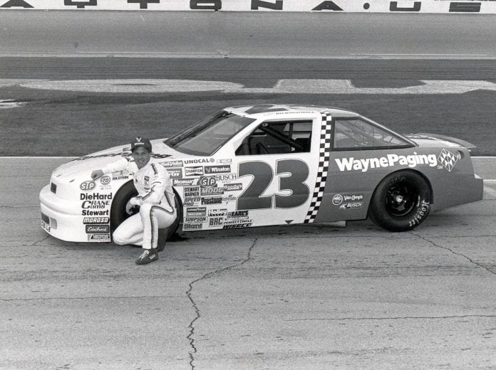 DAYTONA BEACH, FL - FEBRUARY 14: Eddie Bierschwale takes a few pictures next to his car before starting the Daytona 500. Bierschwale would finish 28th and take home $12,080 for the race. (Photo by Racing Photo Archives/Getty Images)