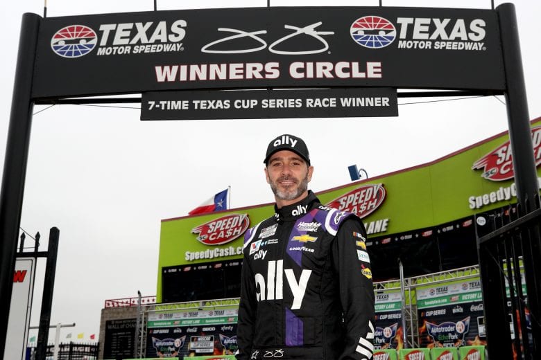 FORT WORTH, TEXAS - OCTOBER 25: Jimmie Johnson, driver of the #48 Ally designed by Noah Sweet Chevrolet, poses in front of the Texas Motor Speedway gate entering victory lane, renamed in his honor prior to the NASCAR Cup Series Autotrader EchoPark Automotive 500 at Texas Motor Speedway on October 25, 2020 in Fort Worth, Texas. Jimmie Johnson is scheduled to retire from full-time NASCAR racing after 2020. (Photo by Chris Graythen/Getty Images) | Getty Images