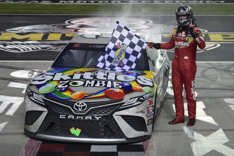 FORT WORTH, TEXAS - OCTOBER 28: Kyle Busch, driver of the #18 Skittles Zombie Toyota, celebrates with the checkered flag after winning the NASCAR Cup Series Autotrader EchoPark Automotive 500 at Texas Motor Speedway on October 28, 2020 in Fort Worth, Texas. (Photo by Jared C. Tilton/Getty Images) | Getty Images