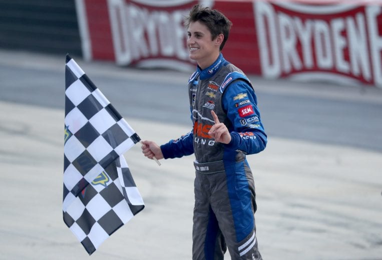 DOVER, DELAWARE - AUGUST 21: Zane Smith, driver of the #21 On The House Cocktail Mix Chevrolet, celebrates with the checkered flag after winning the NASCAR Gander RV & Outdoors Truck Series KDI Office Technology 200 at Dover International Speedway on August 21, 2020 in Dover, Delaware. (Photo by Hunter Martin/Getty Images) | Getty Images