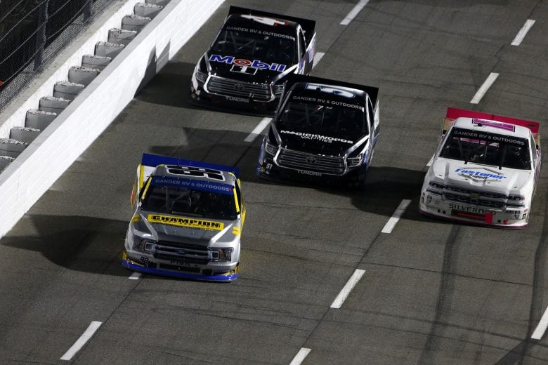 MARTINSVILLE, VIRGINIA - OCTOBER 30: Grant Enfinger, driver of the #98 Champion/Curb Records Ford, Raphael Lessard, driver of the #4 Mobil 1 Toyota, Brandon Jones, driver of the #51 Magick Woods Vanities Toyota, and Jennifer Jo Cobb, driver of the #10 Fastener Supply Company Chevrolet, race during the NASCAR Gander RV & Outdoors Truck Series NASCAR Hall of Fame 200 at Martinsville Speedway on October 30, 2020 in Martinsville, Virginia. (Photo by Brian Lawdermilk/Getty Images) | Getty Images