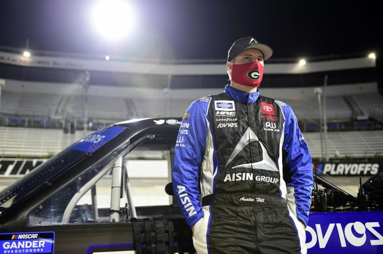 MARTINSVILLE, VIRGINIA - OCTOBER 30: Austin Hill, driver of the #16 AISIN Group Toyota, waits on the grid prior to the NASCAR Gander RV & Outdoors Truck Series NASCAR Hall of Fame 200 at Martinsville Speedway on October 30, 2020 in Martinsville, Virginia. (Photo by Jared C. Tilton/Getty Images) | Getty Images