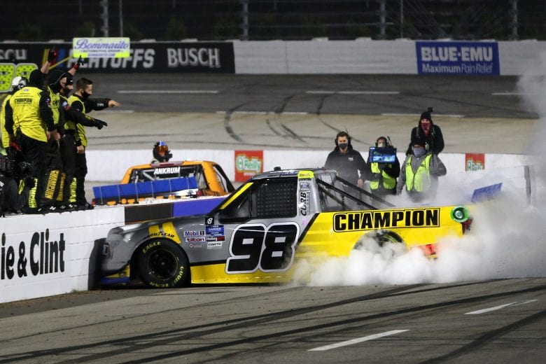 MARTINSVILLE, VIRGINIA - OCTOBER 30: Grant Enfinger, driver of the #98 Champion/Curb Records Ford, celebrates with a burnout after winning the NASCAR Gander RV & Outdoors Truck Series NASCAR Hall of Fame 200 at Martinsville Speedway on October 30, 2020 in Martinsville, Virginia. (Photo by Brian Lawdermilk/Getty Images) | Getty Images