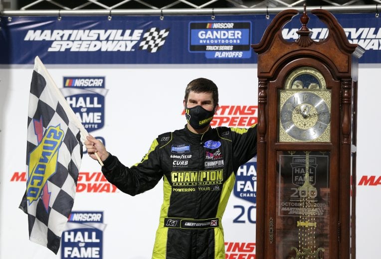 MARTINSVILLE, VIRGINIA - OCTOBER 30: Grant Enfinger, driver of the #98 Champion/Curb Records Ford, celebrates in victory lane after winning the NASCAR Gander RV & Outdoors Truck Series NASCAR Hall of Fame 200 at Martinsville Speedway on October 30, 2020 in Martinsville, Virginia. (Photo by Brian Lawdermilk/Getty Images) | Getty Images