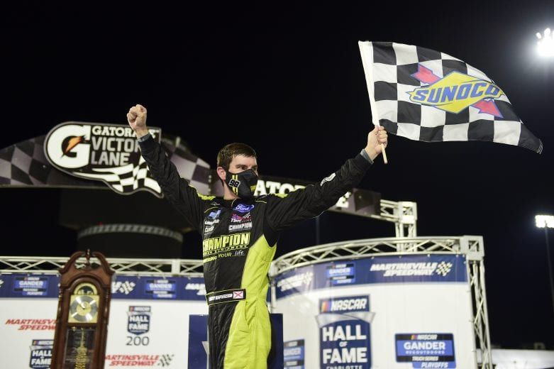 MARTINSVILLE, VIRGINIA - OCTOBER 30: Grant Enfinger, driver of the #98 Champion/Curb Records Ford, celebrates in victory lane after winning the NASCAR Gander RV & Outdoors Truck Series NASCAR Hall of Fame 200 at Martinsville Speedway on October 30, 2020 in Martinsville, Virginia. (Photo by Jared C. Tilton/Getty Images) | Getty Images