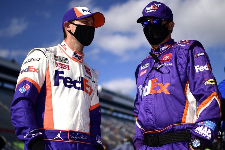 MARTINSVILLE, VIRGINIA - NOVEMBER 01: Denny Hamlin, driver of the #11 FedEx Ground Toyota, and crew member talk on the grid prior to the NASCAR Cup Series Xfinity 500 at Martinsville Speedway on November 01, 2020 in Martinsville, Virginia. (Photo by Jared C. Tilton/Getty Images) | Getty Images
