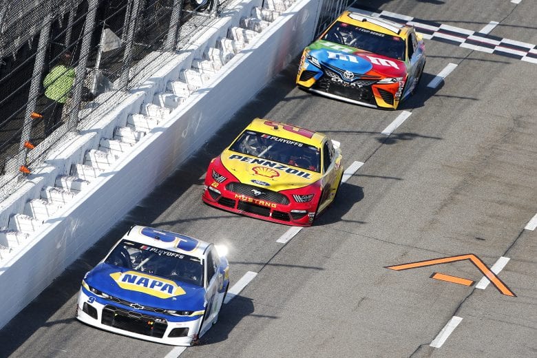 MARTINSVILLE, VIRGINIA - NOVEMBER 01: Joey Logano, driver of the #22 Shell Pennzoil Ford, Chase Elliott, driver of the #9 NAPA Auto Parts Chevrolet, and Kyle Busch, driver of the #18 M&M's Toyota, race during the NASCAR Cup Series Xfinity 500 at Martinsville Speedway on November 01, 2020 in Martinsville, Virginia. (Photo by Brian Lawdermilk/Getty Images) | Getty Images