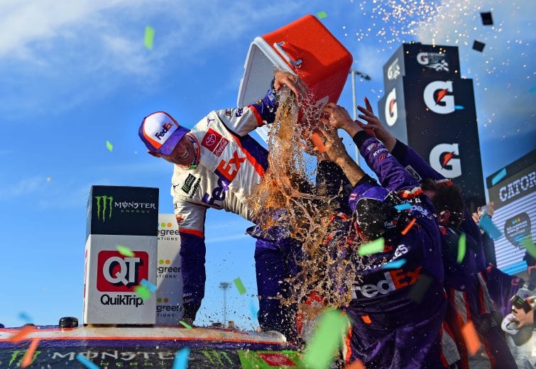 AVONDALE, ARIZONA - NOVEMBER 10: Denny Hamlin, driver of the #11 FedEx Ground Toyota, celebrates in Victory Lane after winning the Monster Energy NASCAR Cup Series Bluegreen Vacations 500 at ISM Raceway on November 10, 2019 in Avondale, Arizona. (Photo by Jared C. Tilton/Getty Images) | Getty Images