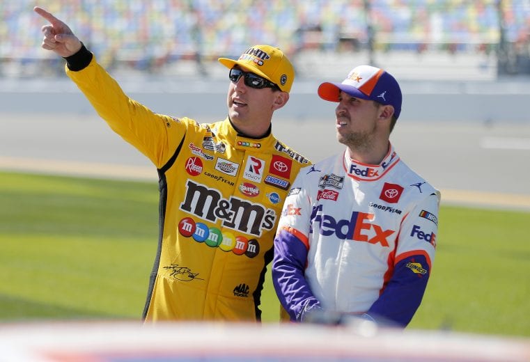 DAYTONA BEACH, FLORIDA - FEBRUARY 09: Kyle Busch, driver of the #18 M&M's Toyota, talks with Denny Hamlin, driver of the #11 FedEx Express Toyota, during qualifying for the NASCAR Cup Series 62nd Annual Daytona 500 at Daytona International Speedway on February 09, 2020 in Daytona Beach, Florida. (Photo by Brian Lawdermilk/Getty Images) | Getty Images