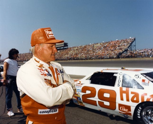 UNKNOWN — 1980s:  Cale Yarborough keeps an eye on the action as he prepares to qualify for a NASCAR Cup race.  After driving for such legendary car owners as the Wood Brothers, Junior Johnson and Harry Ranier, Yarborough formed his own team and drove the No. 29 Oldsmobile on the Cup circuit in both 1988 and 1989 before retiring as a driver.  (Photo by ISC Images & Archives via Getty Images)