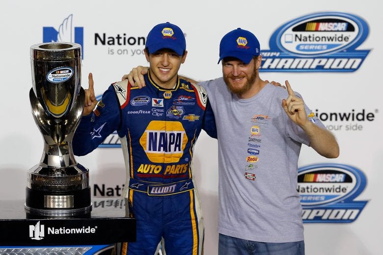 HOMESTEAD, FL - NOVEMBER 15: Chase Elliott, driver of the #9 NAPA Auto Parts Chevrolet, celebrates with the trophy in Victory Lane with team owner Dale Earnhardt jr. after winning the series championship during the NASCAR Nationwide Series Ford EcoBoost 300 at Homestead-Miami Speedway on November 15, 2014 in Homestead, Florida. (Photo by Chris Trotman/Getty Images for NASCAR)