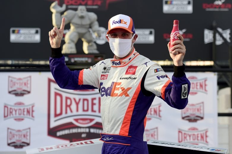 DOVER, DELAWARE - AUGUST 22: Denny Hamlin, driver of the #11 FedEx Office Toyota, celebrates in Victory Lane after winning the NASCAR Cup Series Drydene 311 at Dover International Speedway on August 22, 2020 in Dover, Delaware. (Photo by Jared C. Tilton/Getty Images) | Getty Images