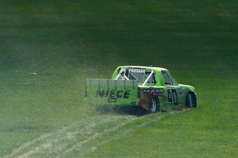 KANSAS CITY, KANSAS - JULY 25: Travis Pastrana, driver of the #40 Plan B Sales Chevrolet, spins into the grass during the NASCAR Gander RV & Outdoors Truck Series e.p.t 200 at Kansas Speedway on July 25, 2020 in Kansas City, Kansas. (Photo by Kyle Rivas/Getty Images) | Getty Images