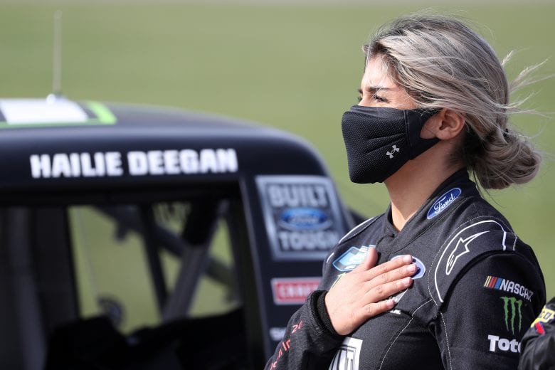 KANSAS CITY, KANSAS - OCTOBER 17: Hailie Deegan, driver of the #17 FORD Ford, stands during the national anthem on the grid prior to the NASCAR Gander RV & Outdoors Truck Series Clean Harbors 200at Kansas Speedway on October 17, 2020 in Kansas City, Kansas. (Photo by Chris Graythen/Getty Images) | Getty Images