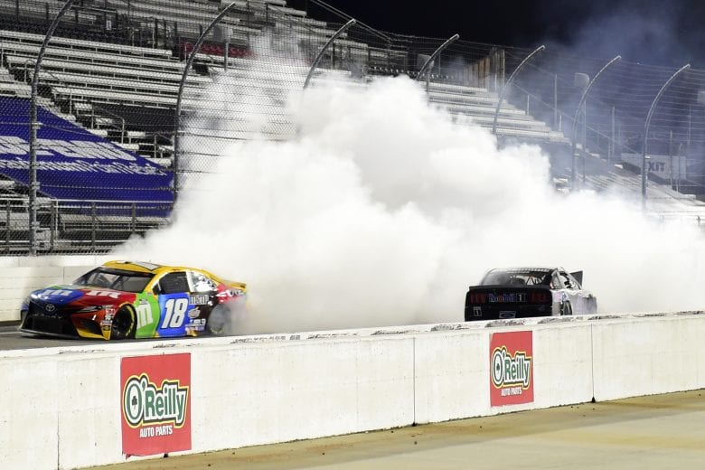 MARTINSVILLE, VIRGINIA - NOVEMBER 01: Kyle Busch, driver of the #18 M&M's Toyota, drives with smoke after an on-track incident with Kevin Harvick, driver of the #4 Mobil 1 Ford, on the last lap during the NASCAR Cup Series Xfinity 500 at Martinsville Speedway on November 01, 2020 in Martinsville, Virginia. (Photo by Jared C. Tilton/Getty Images) | Getty Images