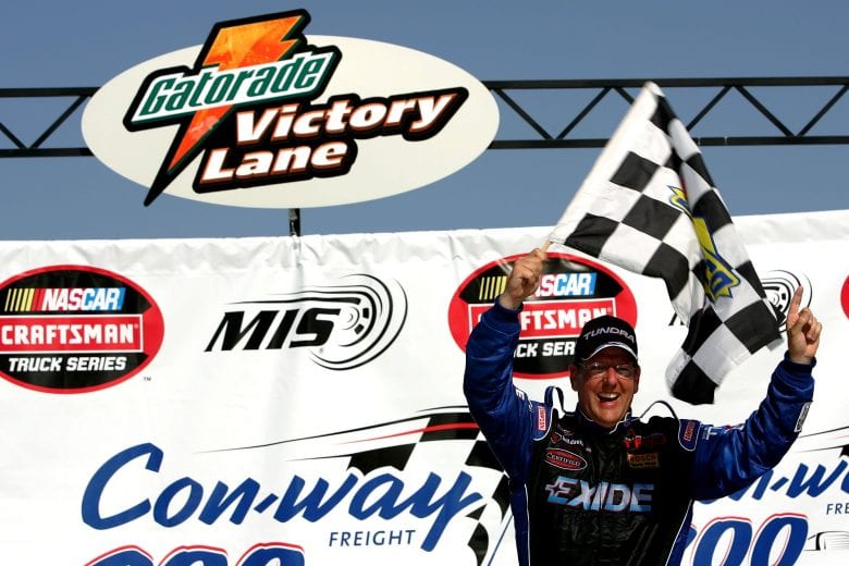 BROOKLYN, MI - JUNE 17:  Johnny Benson, driver of the #23 Exide Batteries Toyota, celebrates after winning the NASCAR Craftsman Truck Series Con-way Freight 200 at the Michigan International Speedway June 17, 2006 in Brooklyn, Michigan.  (Photo by Harry How/Getty Images) | Getty Images