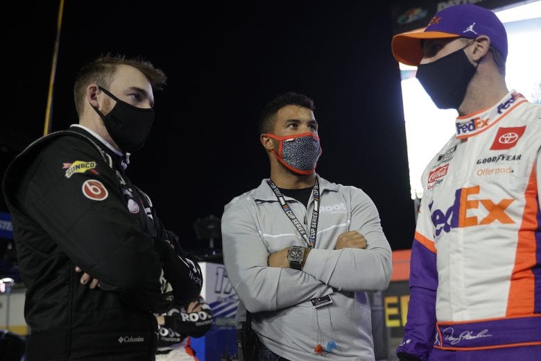 DAYTONA BEACH, FLORIDA - FEBRUARY 09: Ty Dillon, driver of the #23 Root Insurance Toyota, Bubba Wallace and Denny Hamlin, driver of the #11 FedEx Express Toyota, talk on the grid prior to the NASCAR Cup Series Busch Clash at Daytona at Daytona International Speedway on February 09, 2021 in Daytona Beach, Florida. (Photo by Chris Graythen/Getty Images) | Getty Images