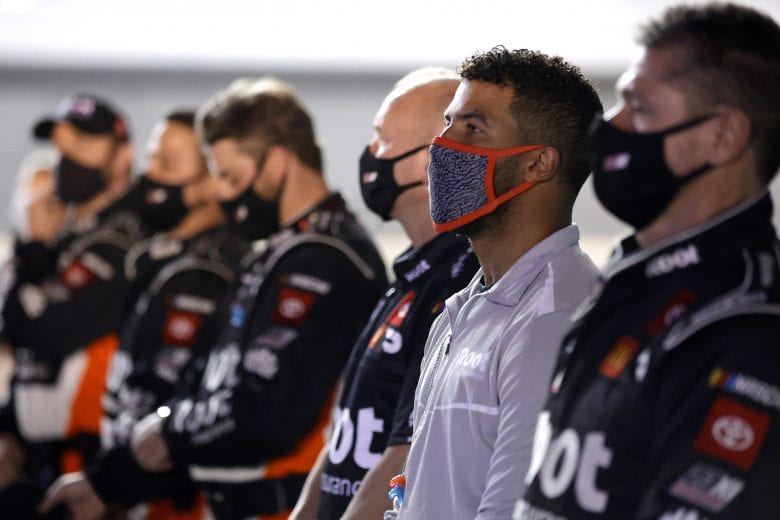 DAYTONA BEACH, FLORIDA - FEBRUARY 09: Bubba Wallace and the #23 Root Insurance Toyota, crew stand on the grid during pre-race ceremonies prior to the NASCAR Cup Series Busch Clash at Daytona at Daytona International Speedway on February 09, 2021 in Daytona Beach, Florida. (Photo by Jared C. Tilton/Getty Images) | Getty Images