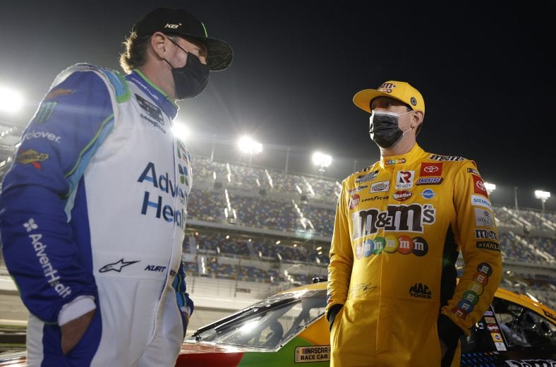 DAYTONA BEACH, FLORIDA - FEBRUARY 09: Kyle Busch, driver of the #18 M&M's Toyota, and Kurt Busch, driver of the #1 AdventHealth Chevrolet, talk on the grid prior to the NASCAR Cup Series Busch Clash at Daytona at Daytona International Speedway on February 09, 2021 in Daytona Beach, Florida. (Photo by Jared C. Tilton/Getty Images) | Getty Images