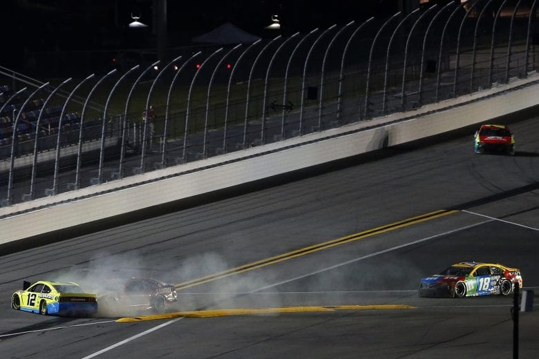 DAYTONA BEACH, FLORIDA - FEBRUARY 09: Ryan Blaney, driver of the #12 Menards/Great Lakes Flooring Ford, and Chase Elliott, driver of the #9 Llumar Chevrolet, wreck as Kyle Busch, driver of the #18 M&M's Toyota, drives past to win the NASCAR Cup Series Busch Clash at Daytona at Daytona International Speedway on February 09, 2021 in Daytona Beach, Florida. (Photo by Brian Lawdermilk/Getty Images) | Getty Images