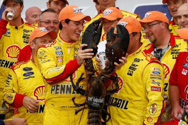 LOUDON, NH - SEPTEMBER 21: Joey Logano, driver of the #22 Shell-Pennzoil Ford, receives a lobster in victory lane after winning the NASCAR Sprint Cup Series Sylvania 300 at New Hampshire Motor Speedway on September 21, 2014 in Loudon, New Hampshire. (Photo by Jeff Zelevansky/NASCAR via Getty Images)