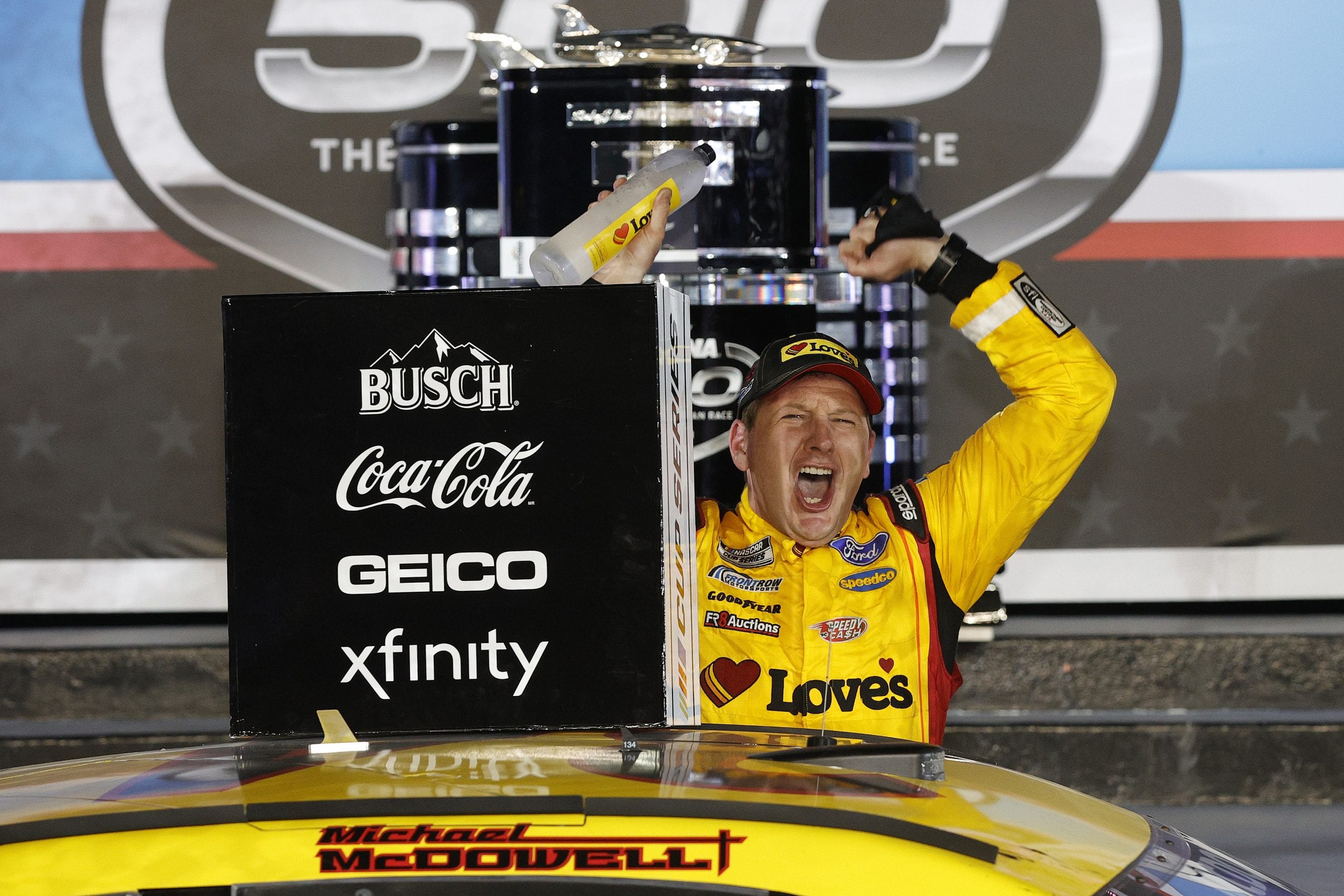DAYTONA BEACH, FLORIDA - FEBRUARY 14: Michael McDowell, driver of the #34 Love's Travel Stops Ford, celebrates in victory lane after winning the NASCAR Cup Series 63rd Annual Daytona 500 at Daytona International Speedway on February 14, 2021 in Daytona Beach, Florida. (Photo by Chris Graythen/Getty Images) | Getty Images