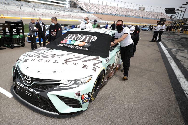 LAS VEGAS, NEVADA - MARCH 07: Crewmembers push the #18 Ethel M Chocolates Toyota, driven by Kyle Busch onto the grid prior to the NASCAR Cup Series Pennzoil 400 presented by Jiffy Lube at the Las Vegas Motor Speedway on March 07, 2021 in Las Vegas, Nevada. (Photo by Chris Graythen/Getty Images) | Getty Images