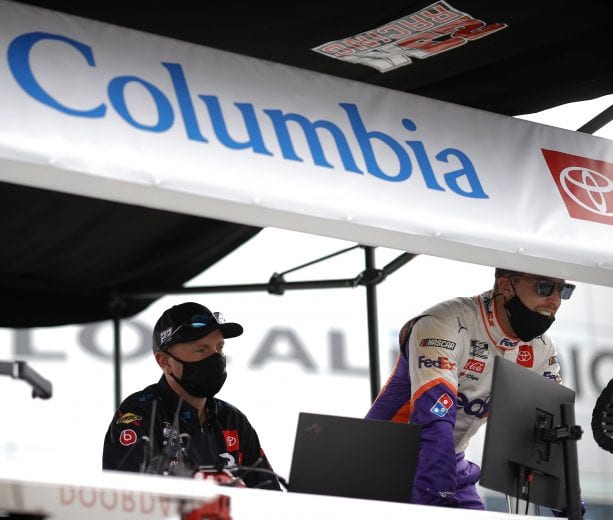 LAS VEGAS, NEVADA - MARCH 07: Michael Wheeler(L), crew chief of the #23 Columbia Sportswear Toyota, and Denny Hamlin, driver of the #11 FedEx Ground Toyota, look on from the pit box prior to the NASCAR Cup Series Pennzoil 400 presented by Jiffy Lube at the Las Vegas Motor Speedway on March 07, 2021 in Las Vegas, Nevada. (Photo by Chris Graythen/23XI Racing via Getty Images)